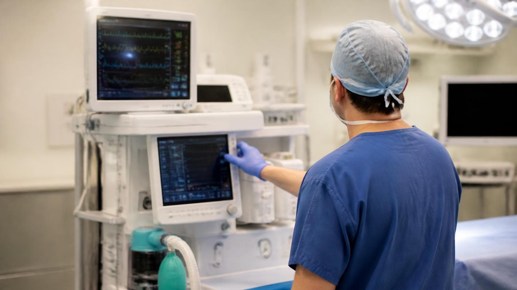 An anaesthetist checking equipment and monitors in an operating theatre, illustrative AI-generated imagery